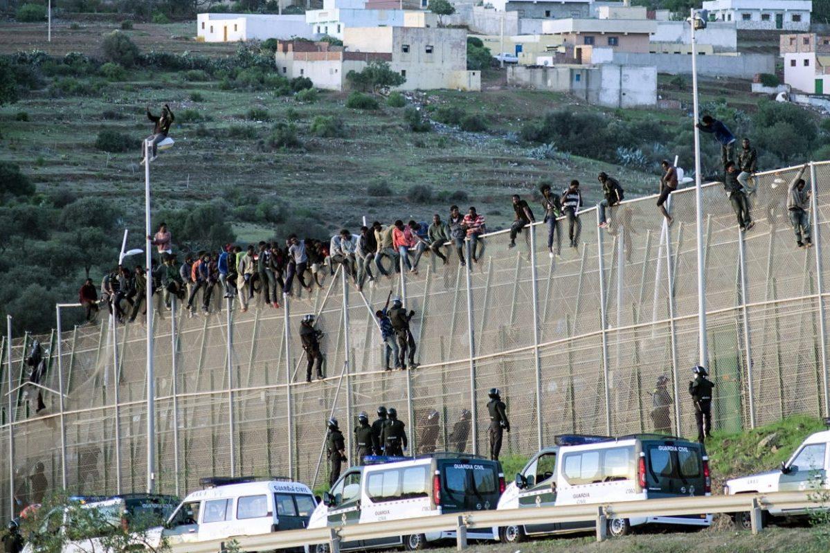 Hundreds of migrants storm Spanish enclave in North Africa, one dies