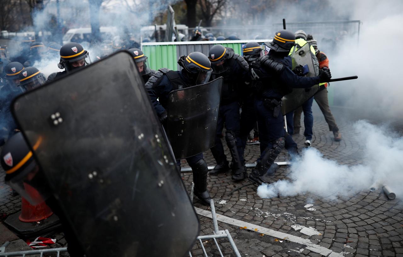 French police fire tear gas at protesters on Champs Elysees