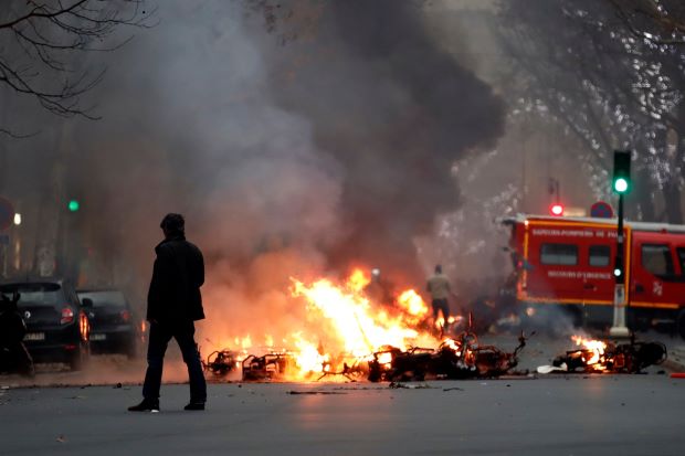 Clashes erupt in Paris as 'yellow vests' protest at unrepentant Macron